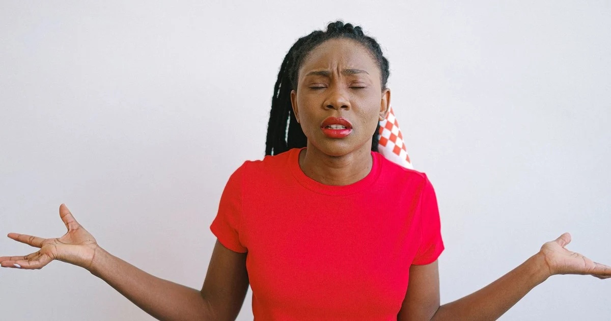 Woman looking confused and unsure, illustrating the search to understand PCOS symptoms