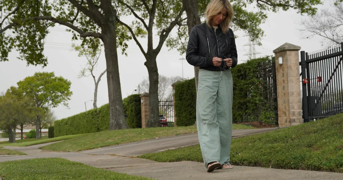 Woman in her 50s walking outdoors on a path