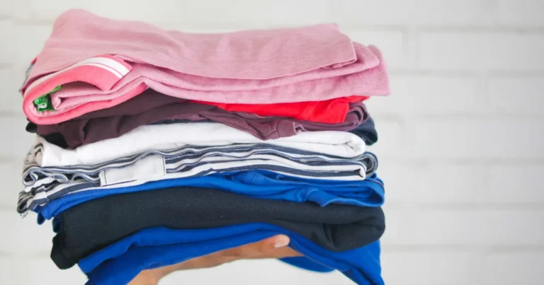 Stack of soft folded clothes in pink, white and blue