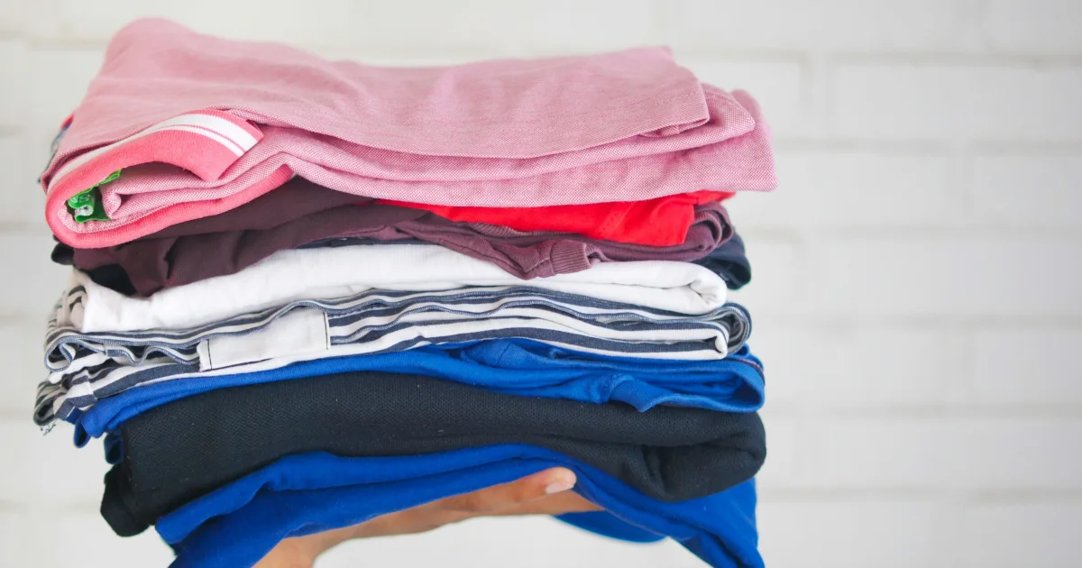 Stack of soft folded clothes in pink, white and blue